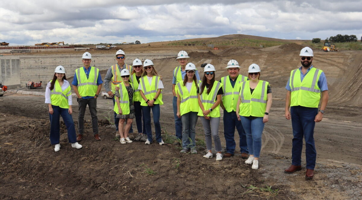 Members of Texas Water Development Board and Texas Water Conservation Association pose for a photo in front of the future Lake Ralph Hall and Leon Hurse Dam.